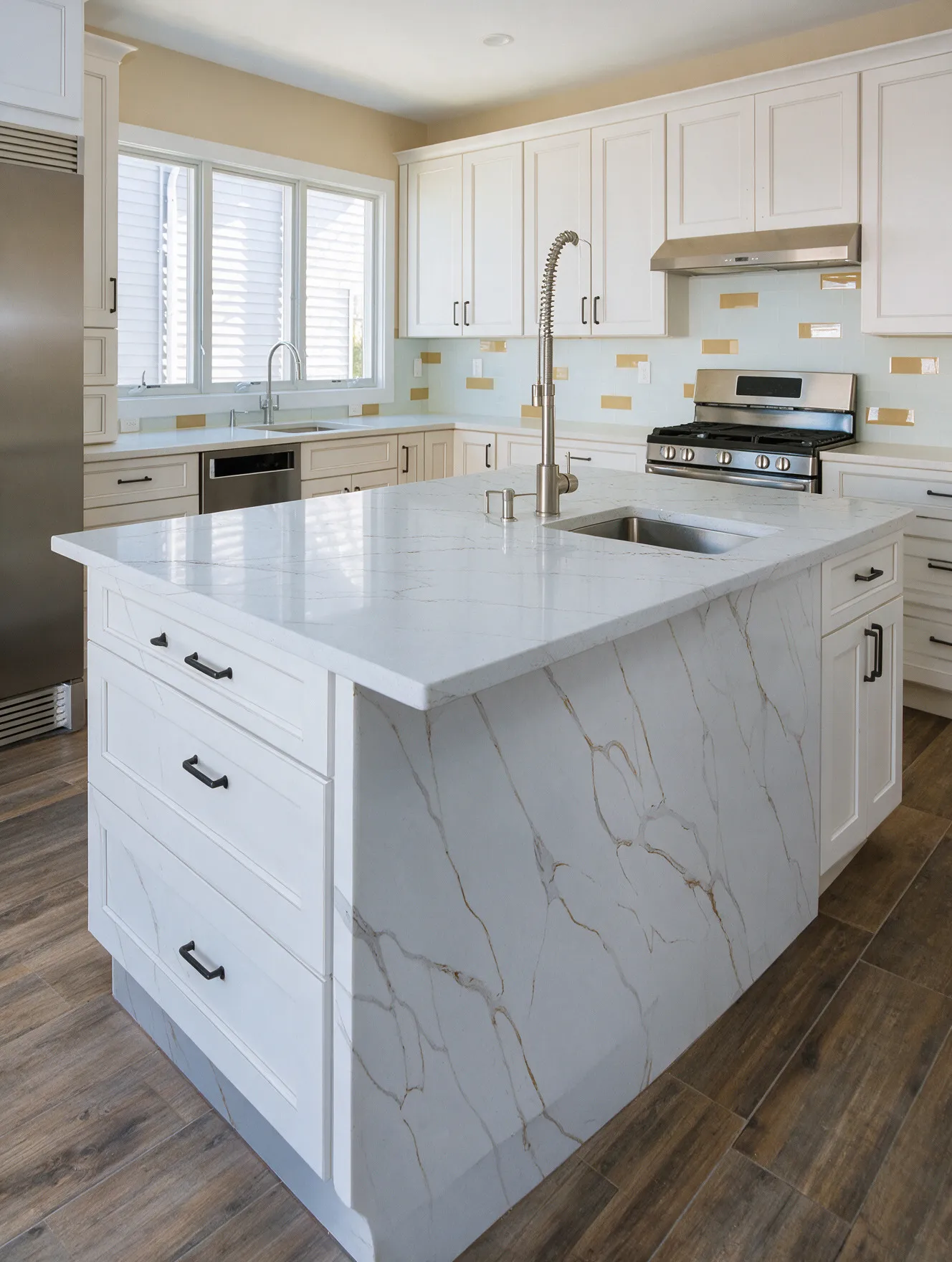 Kitchen island with a waterfall quartz countertop