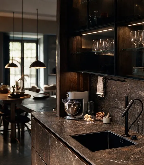 Kitchen with dark stone countertops